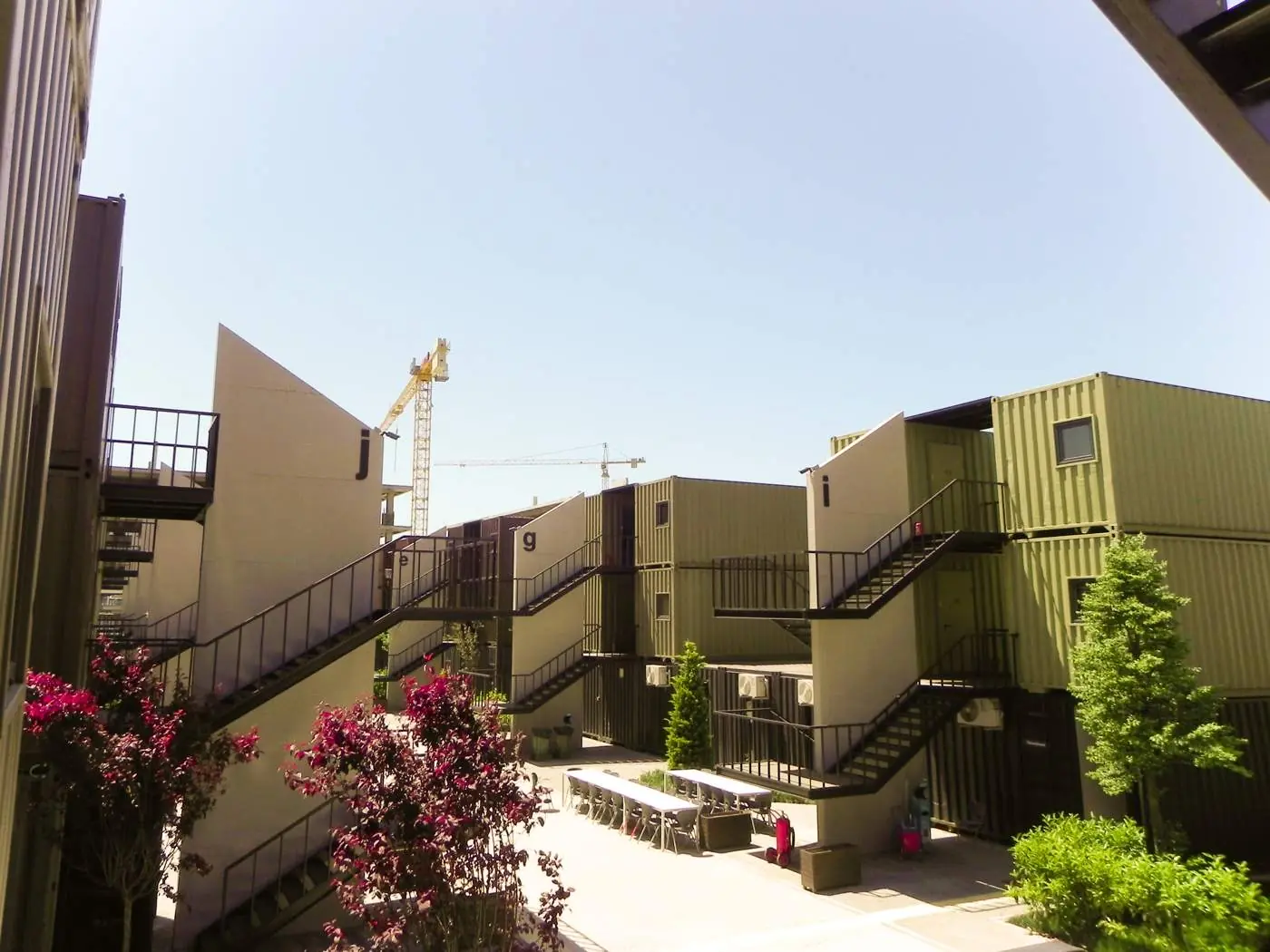 Modified shipping containers forming a multi-storey complex